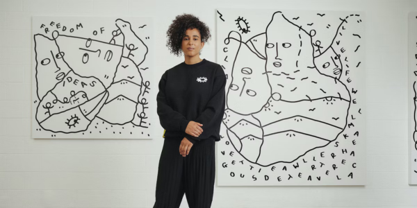 Shantell Martin standing in front of black and white artwork